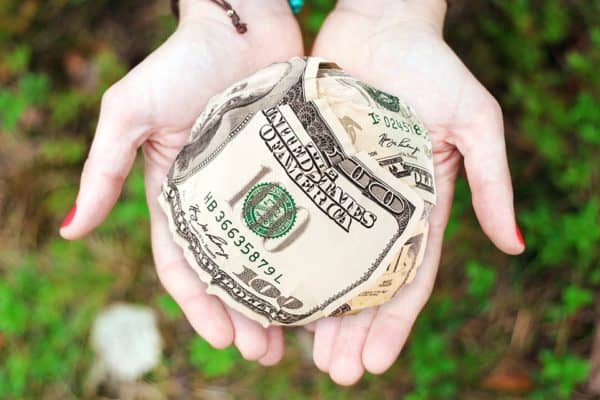 hands taking cash out of a wallet